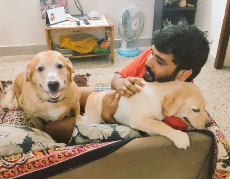 Pradeep Antony playing with his pet dogs