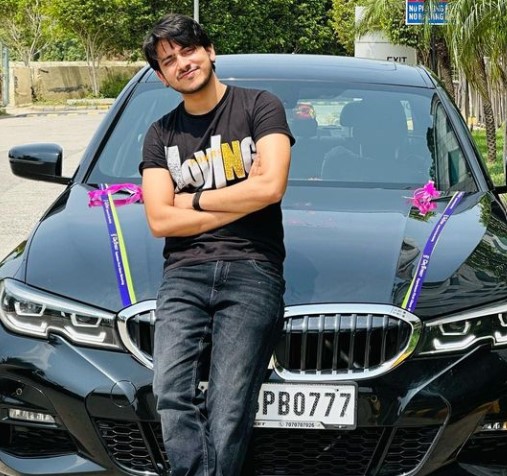 Purav Jha posing with his BMW