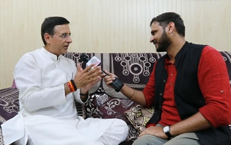 Rajat Sain doing an interview of Randeep Surjewala (left)