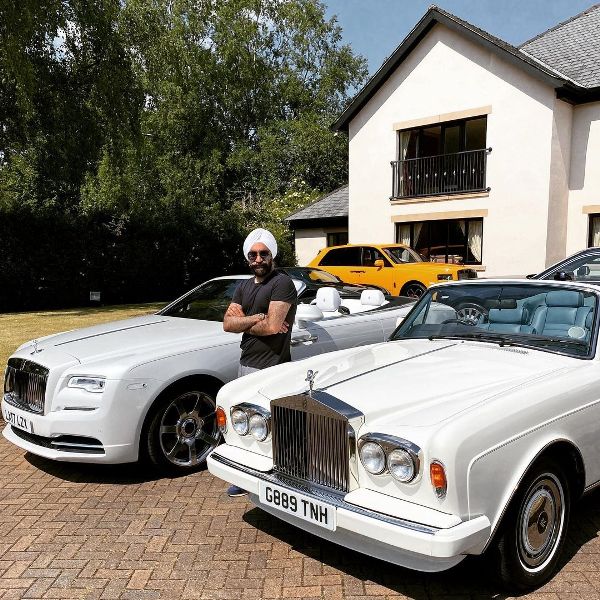 Reuben Singh posing with his Rolls-Royce Corniche and Rolls-Royce Dawn