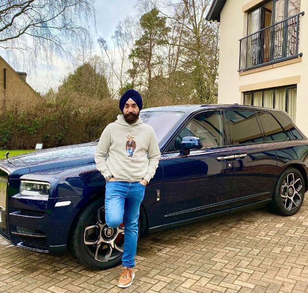Reuben Singh posing with his blue Rolls Royce