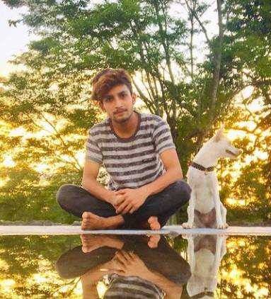 Rohit Chetry posing with his dog