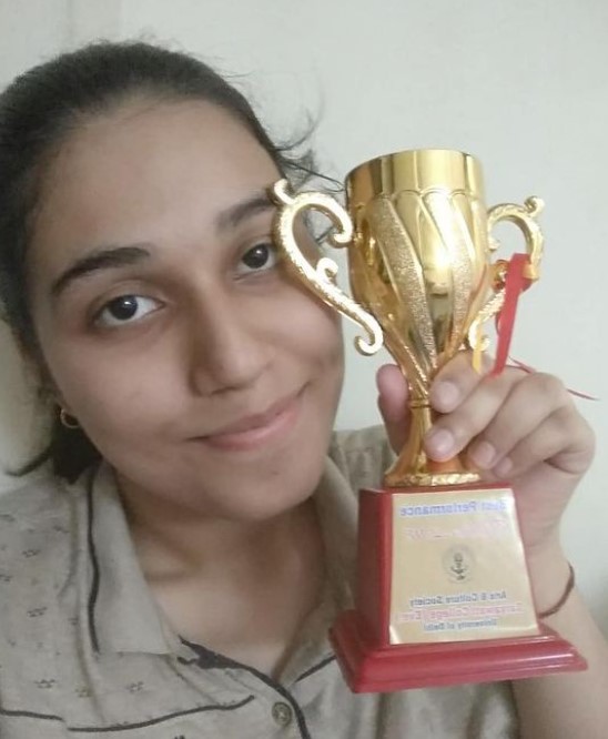 Saloni Gaur with an award she won at a Comedy show