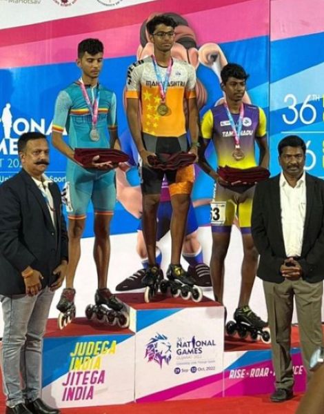 Siddhant Rahul Kamble standing on the podium at the award ceremony of the 2022 National Games in Gujarat