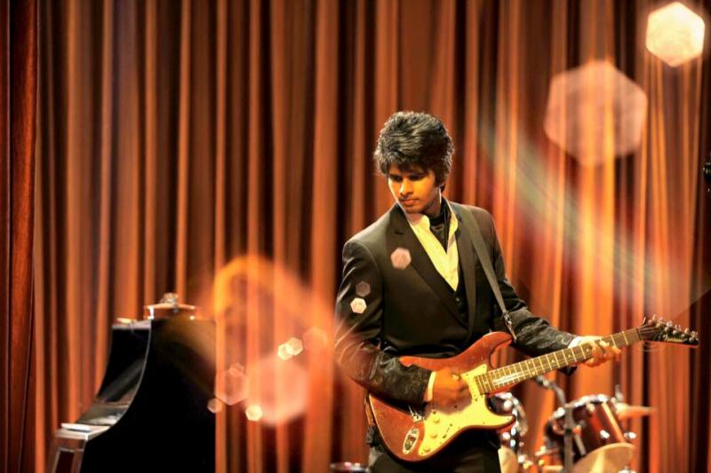 Snehith Gowda playing guitar