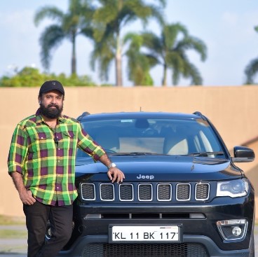 Sudheesh posing with his Jeep