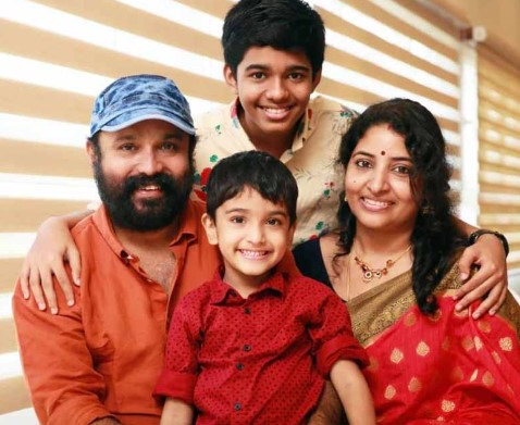 Sudheesh posing with his wife and sons