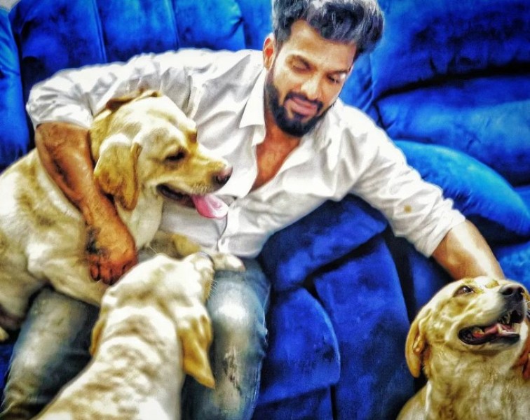 Vinay Gowda playing with his pet dogs