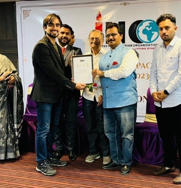 Vishal Pinjani receiving the Social Impact Award