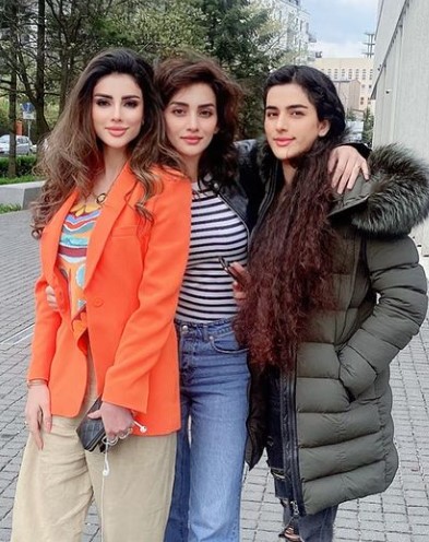 Wazhma Ayoubi (orange dress) with her sisters, Nilofar (middle) and Fatima (right)