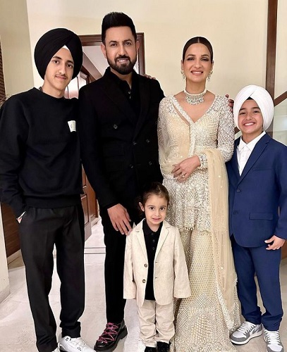 A picture of Ravneet Grewal with her husband and children