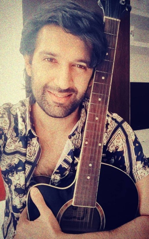 Arjun Aneja with a guitar