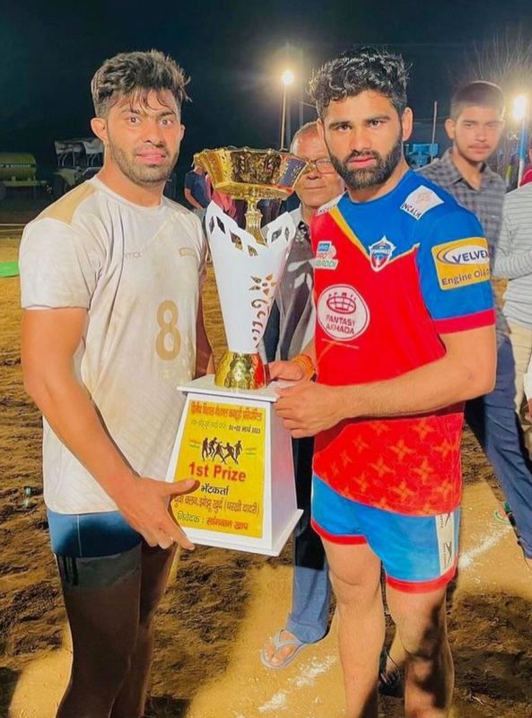 Banty (left) after winning trophy in a Kabaddi tournament