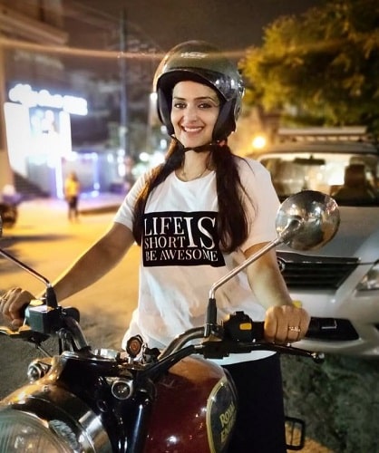 Divya Pillai riding a motorcycle