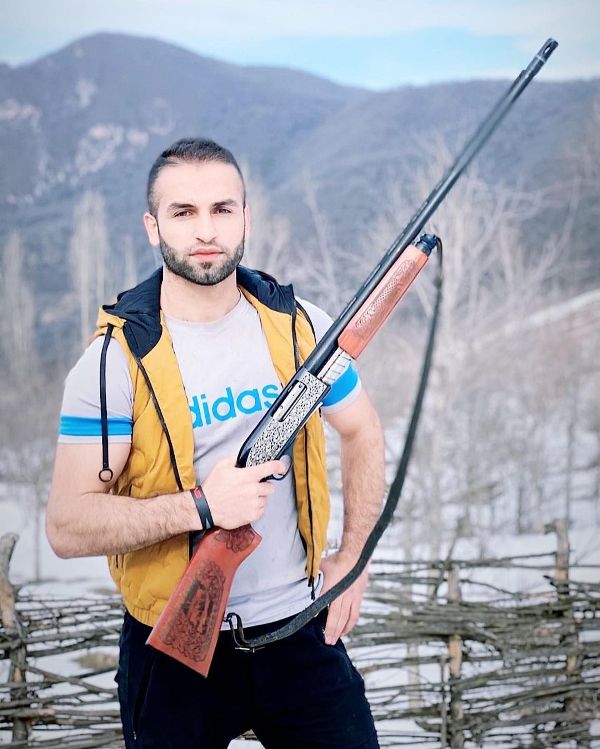 Fazel Atrachali holding a rifle