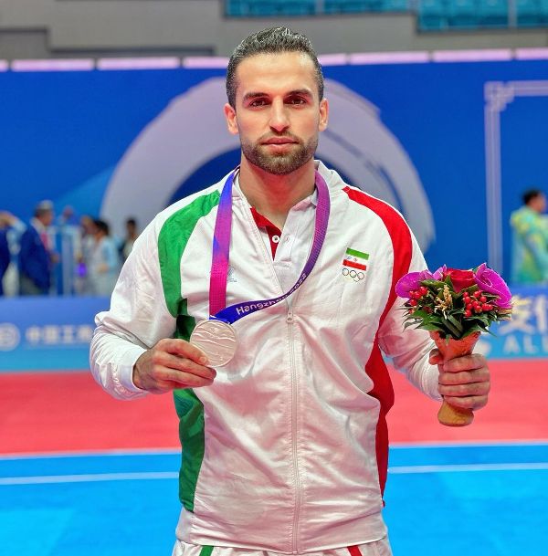 Fazel Atrachali with the silver medal at the 19th Asian Games