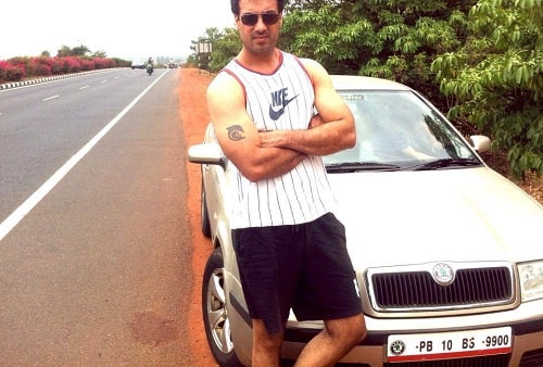 Gavie Chahal posing with his car