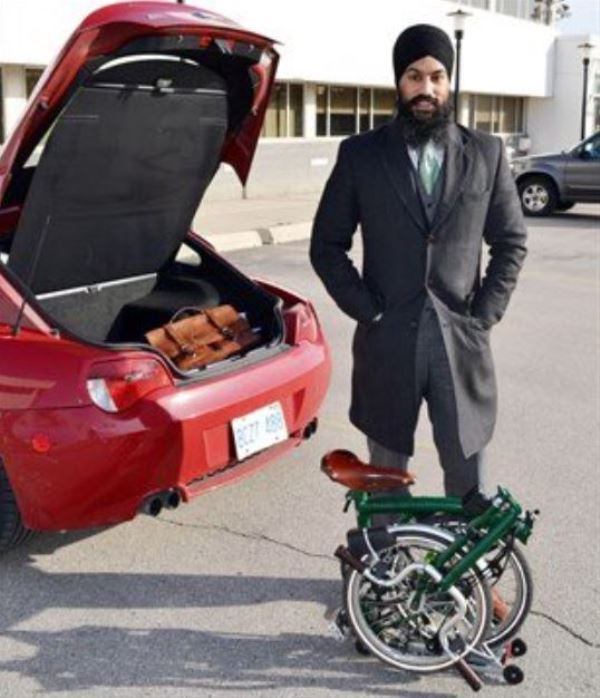 Jagmeet Singh posing with his fold-up bike