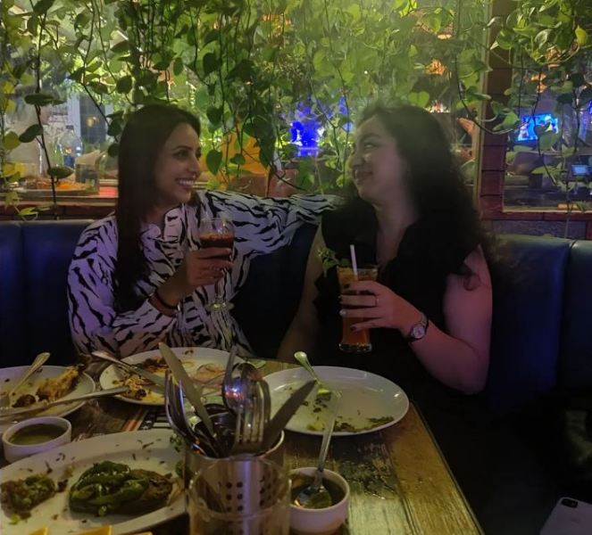Khushboo Kamal (left) while consuming an alcoholic beverage with a friend