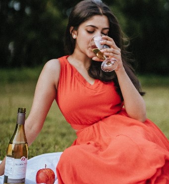 Meenakshi Dinesh while enjoying white wine