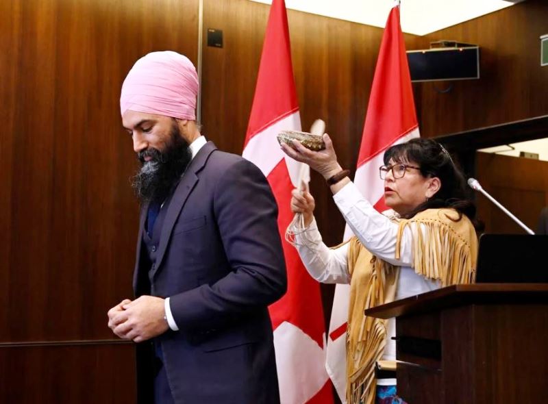 NDP Leader Jagmeet Singh participates in a smudging ceremony with Elder Verna McGregor before being sworn in as MP for Burnaby South during a ceremony in Ottawa