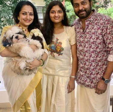 Narain Ram posing with his family and pet