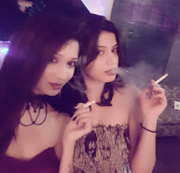 Pavi Poovappa smoking a cigarette with her friend