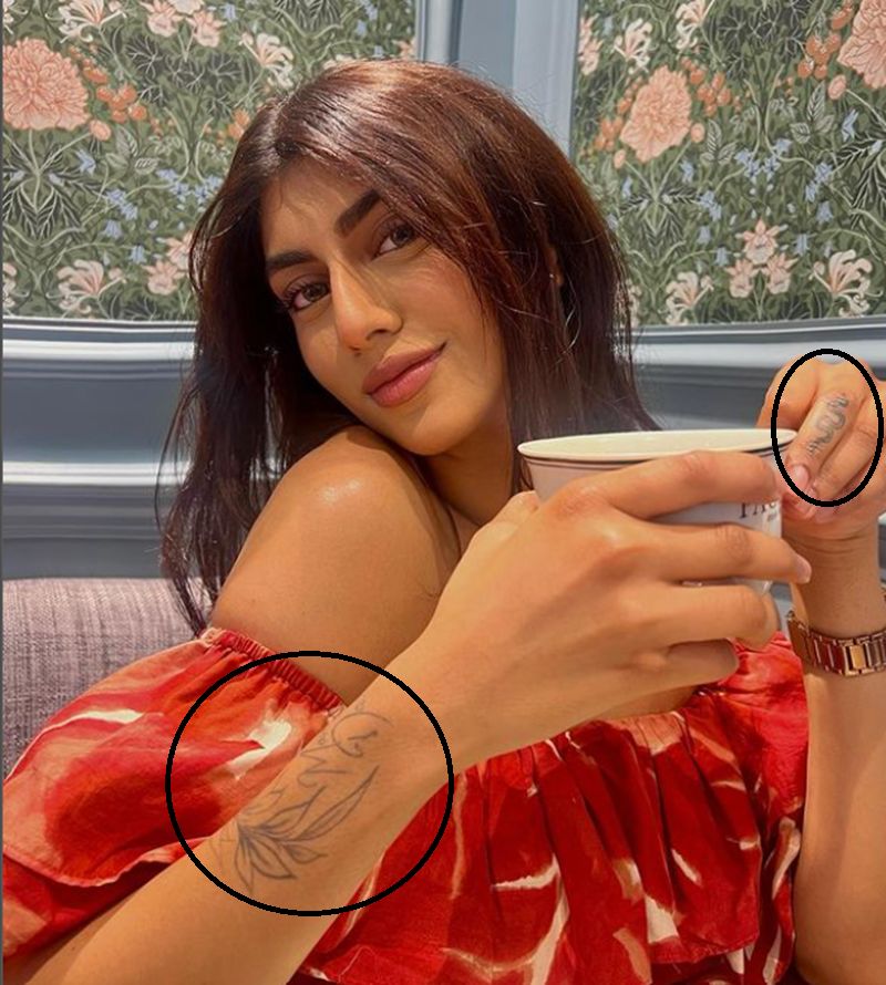 Rajvi Brahmbhatt's tattoo on her hand and middle finger