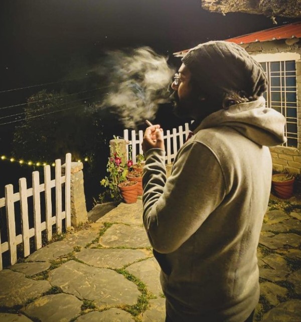 Ravi Gupta smoking a cigarette