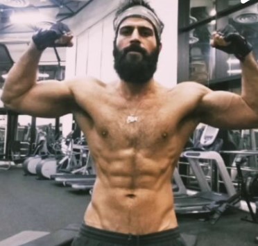 Sajjad Delafrooz posing while at a gym