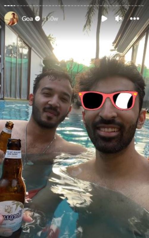 Samadh enjoying an alcoholic drink with his friend in a pool
