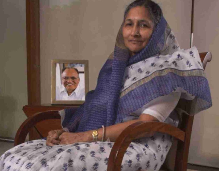 Savitri Jindal sitting next to a picture of her husband Om Prakash Jindal