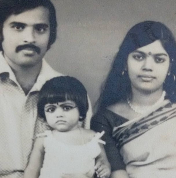 A childhood picture of Manju Pillai with her father and mother