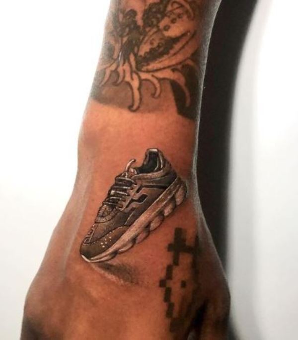 A sneaker tattoo inked on Salehe Bembury's right hand
