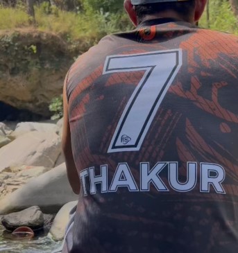 Abhishek Singh Thakur while showing his jersey number
