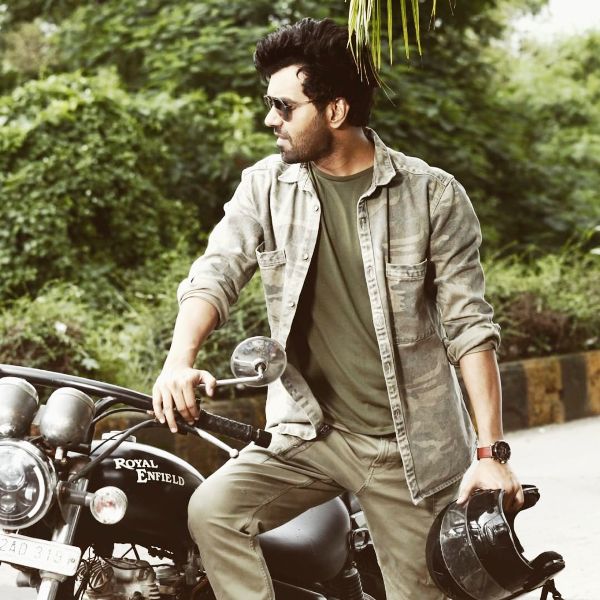 Abhishek Singh posing for a photo with his Royal Enfield