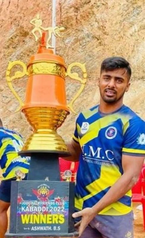Abhishek posing with his trophy after the Kabaddi tournament in Jodhupala, Karnataka