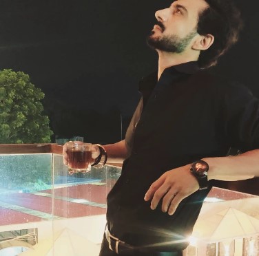 Avi Rakheja while drinking an alcoholic beverage