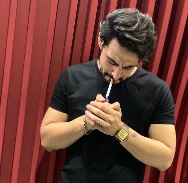 Avi Rakheja while smoking a cigarette