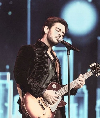 Azaan Sami Khan playing a guitar