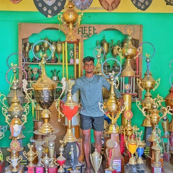 Balaji D with the collection of trophies won by him