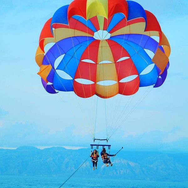 Hamid Nader paragliding with his wife (left)