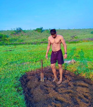 Maharudra Garje while digging soil in his fields