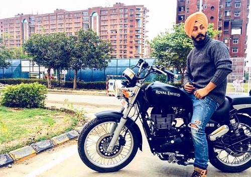 Manjot Singh posing on his motorcycle