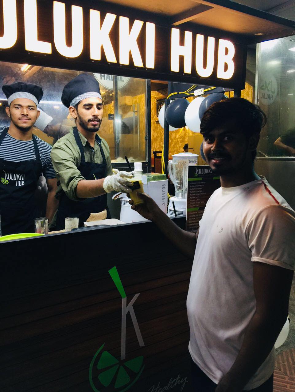 Mohammed Ashiq serving a customer at his juice hub, Kulukki Hub