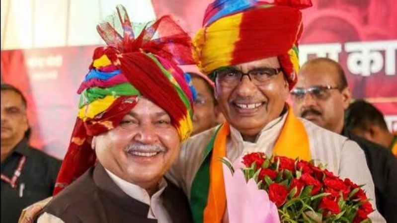 Narendra Singh Tomar (left) with Shivraj Singh Chouhan on being appointed as the convenor of BJP election management panel for MP