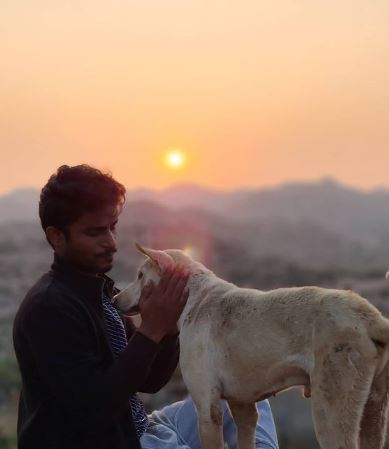 Naveen Shankar posing with a dog