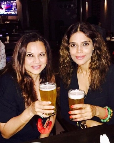 Neelam Singh holding a glass of beer
