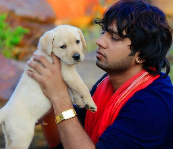 Neelkamal Singh while playing with a puppy