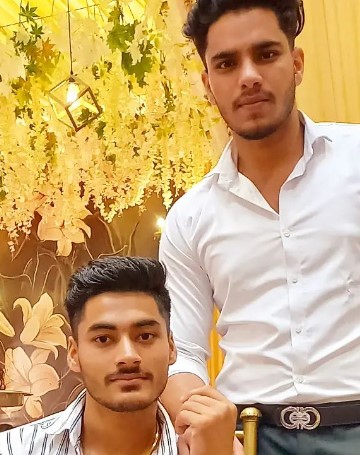 Nitin Kumar (sitting) with his brother (standing)